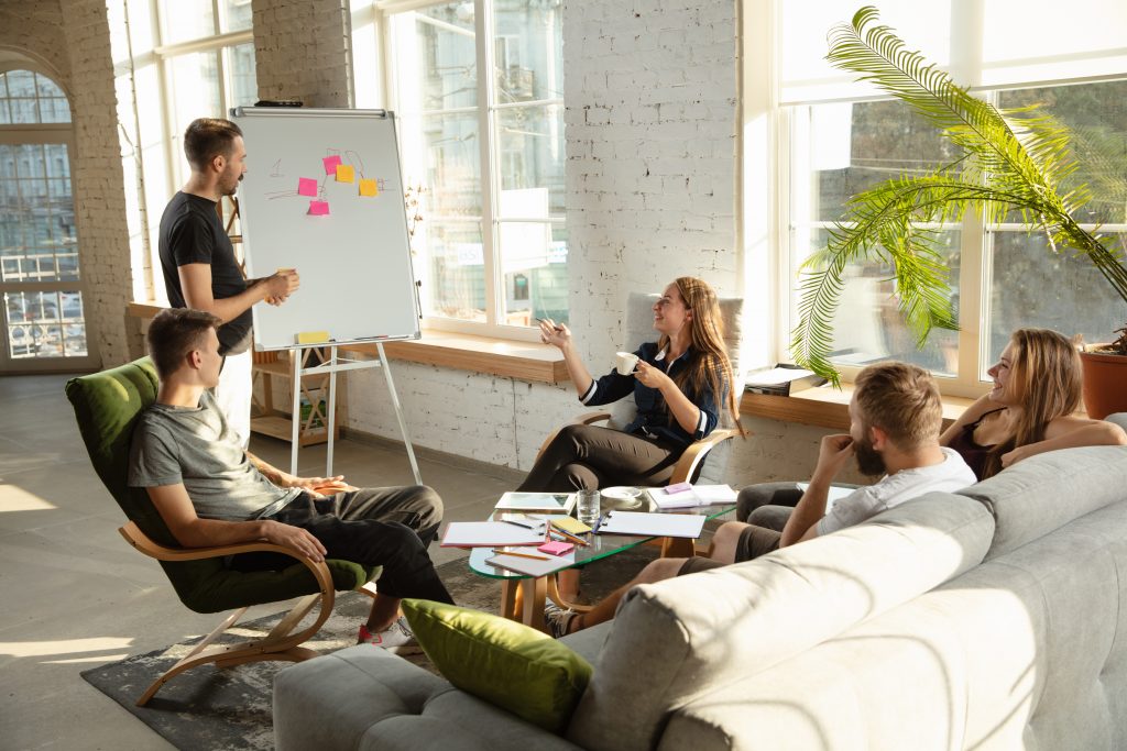 Group of young caucasian office workers have creative meeting to discuss new ideas